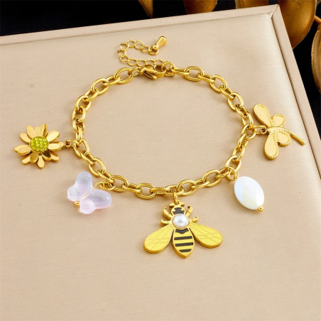 Bracciale ape con ciondoli floreali e perla su tessuto chiaro