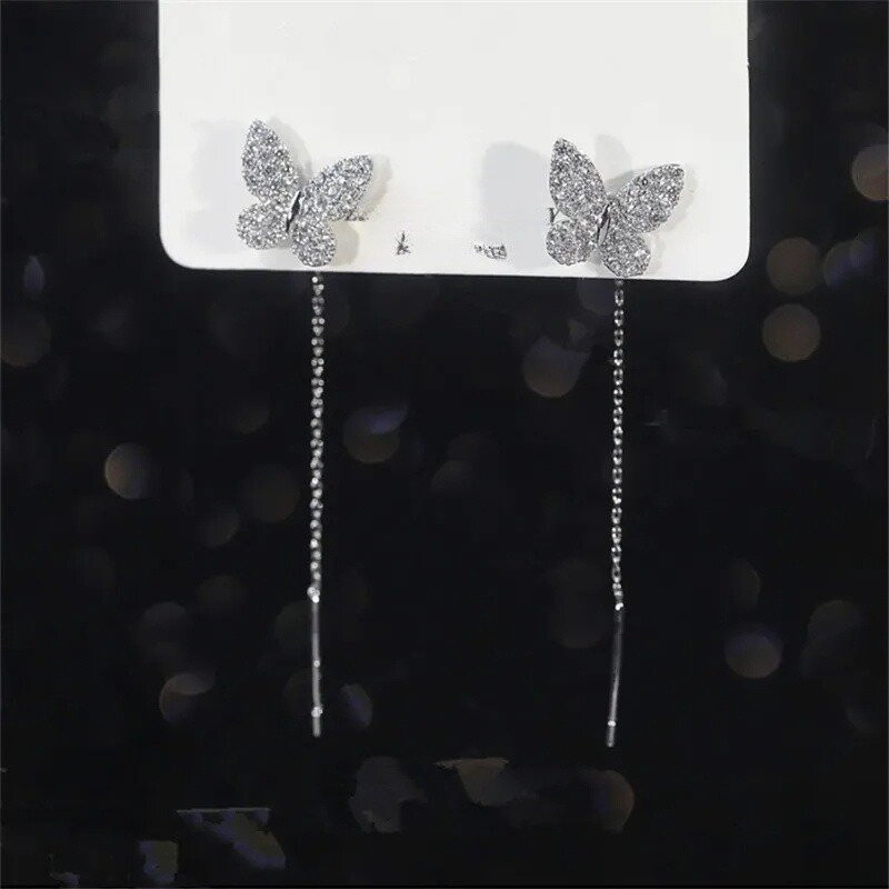 détails Boucles d'oreilles papillon en or et argent avec long pendant
