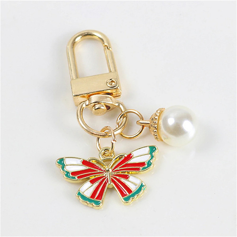 Porte-clés papillon aux couleurs vives avec perle Blanche - modèle 1